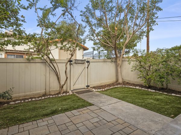 Interior of fenced private front yard. Gated & somewhat secluded community pool (1 of multiple pools) located just outside front gate.